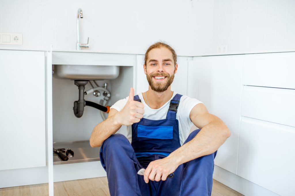 Benefits of Upgrading Your Plumbing Fixtures Today 8 handsome plumber at the kitchen 2023 11 27 05 33 54 utc scaled